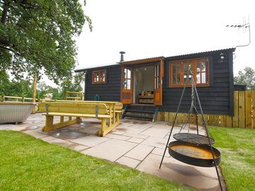 Patio with a woodfired hot tub and barbecue